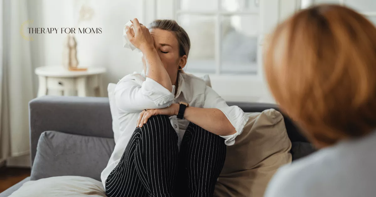 Mother crying during therapy session, showing postpartum depression, overwhelm, and need for mental health support.