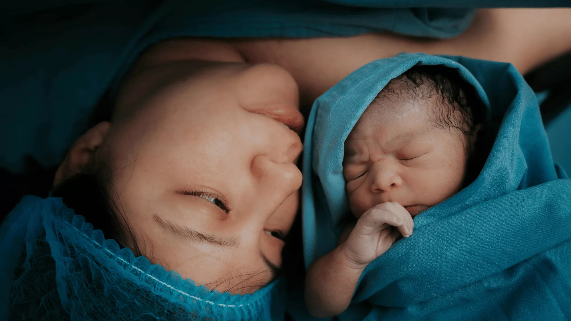 Mother and her newborn baby connecting after searching for "postpartum support near me", and connecting with a therapist.